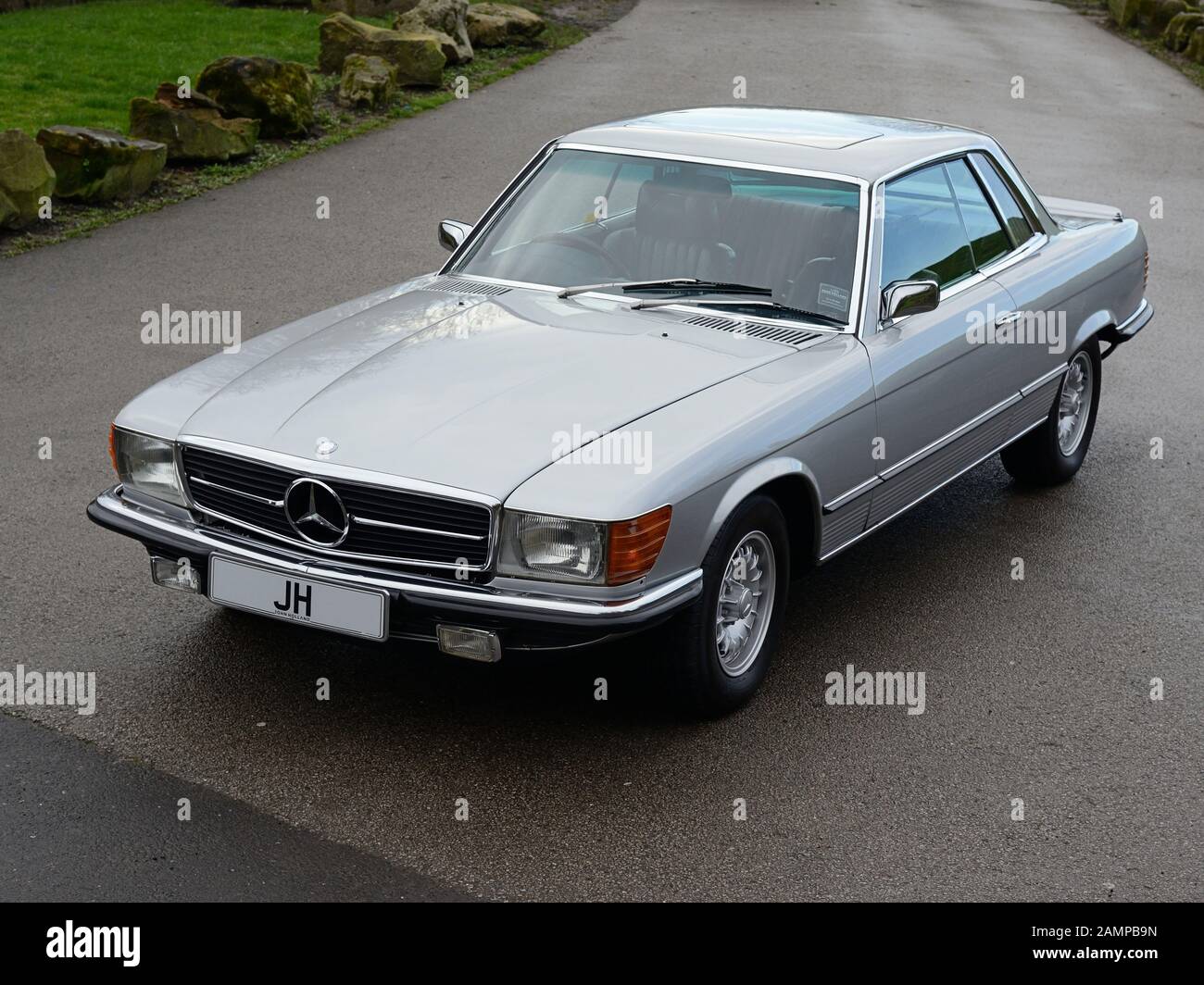 Mercedes Benz 450SLC (C107) parked on a wide driveway. Stock Photo