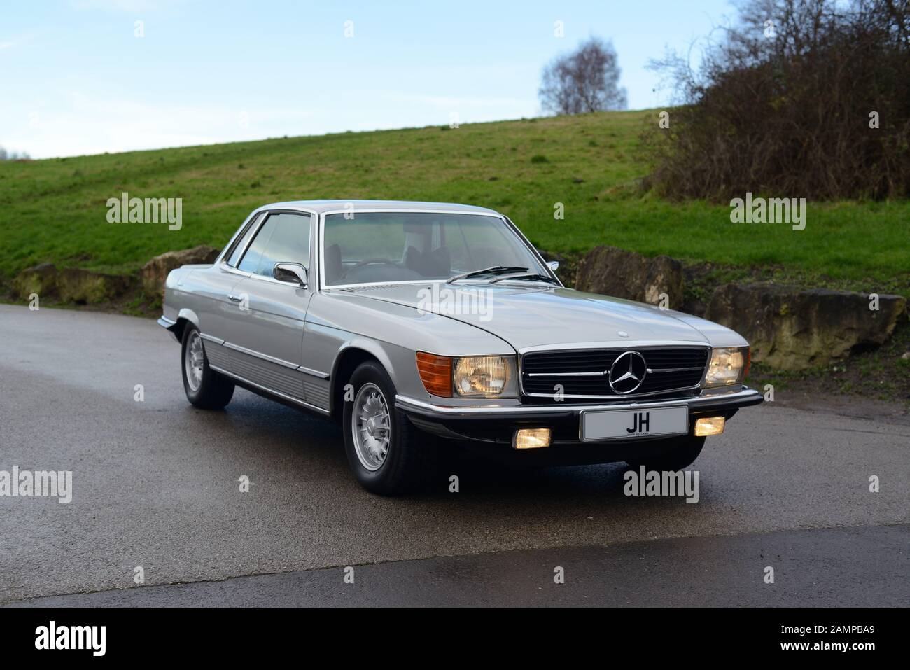 Mercedes Benz 450SLC (C107) parked on a wide driveway. Stock Photo
