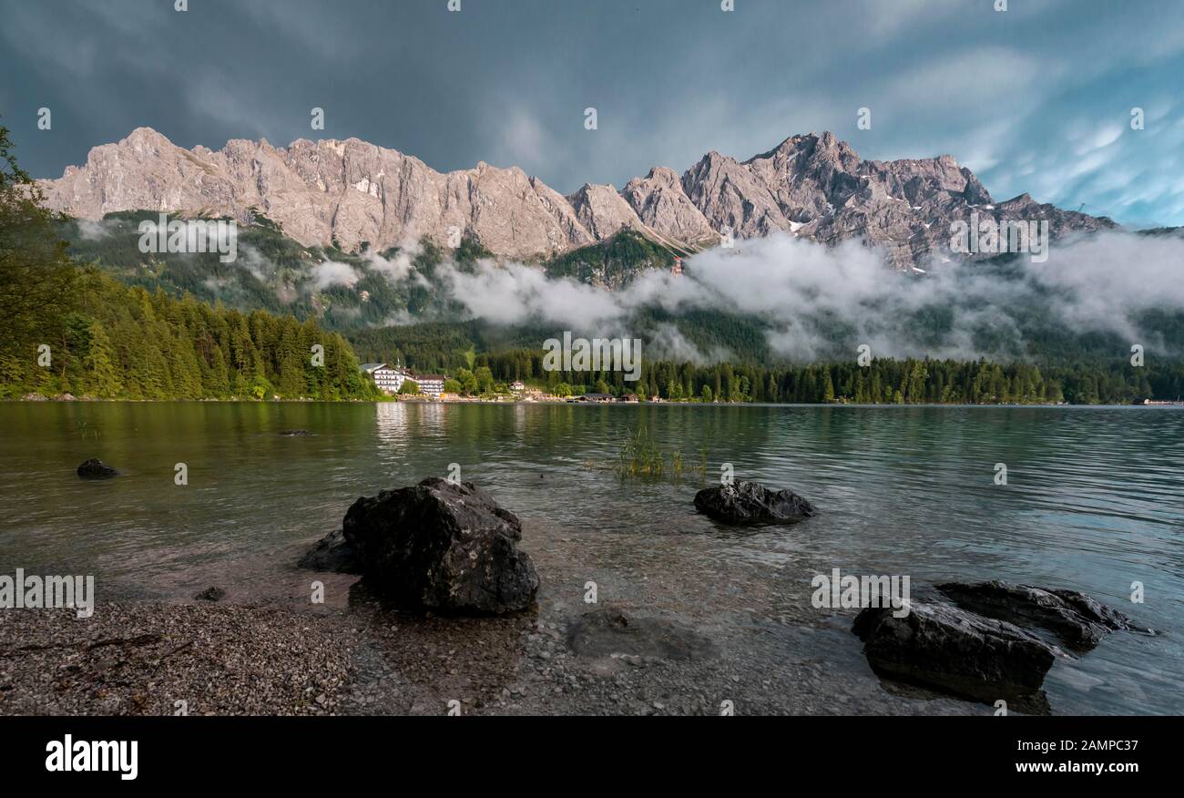 Rocks on the shore, Eibsee lake in front of Zugspitze massif with ...