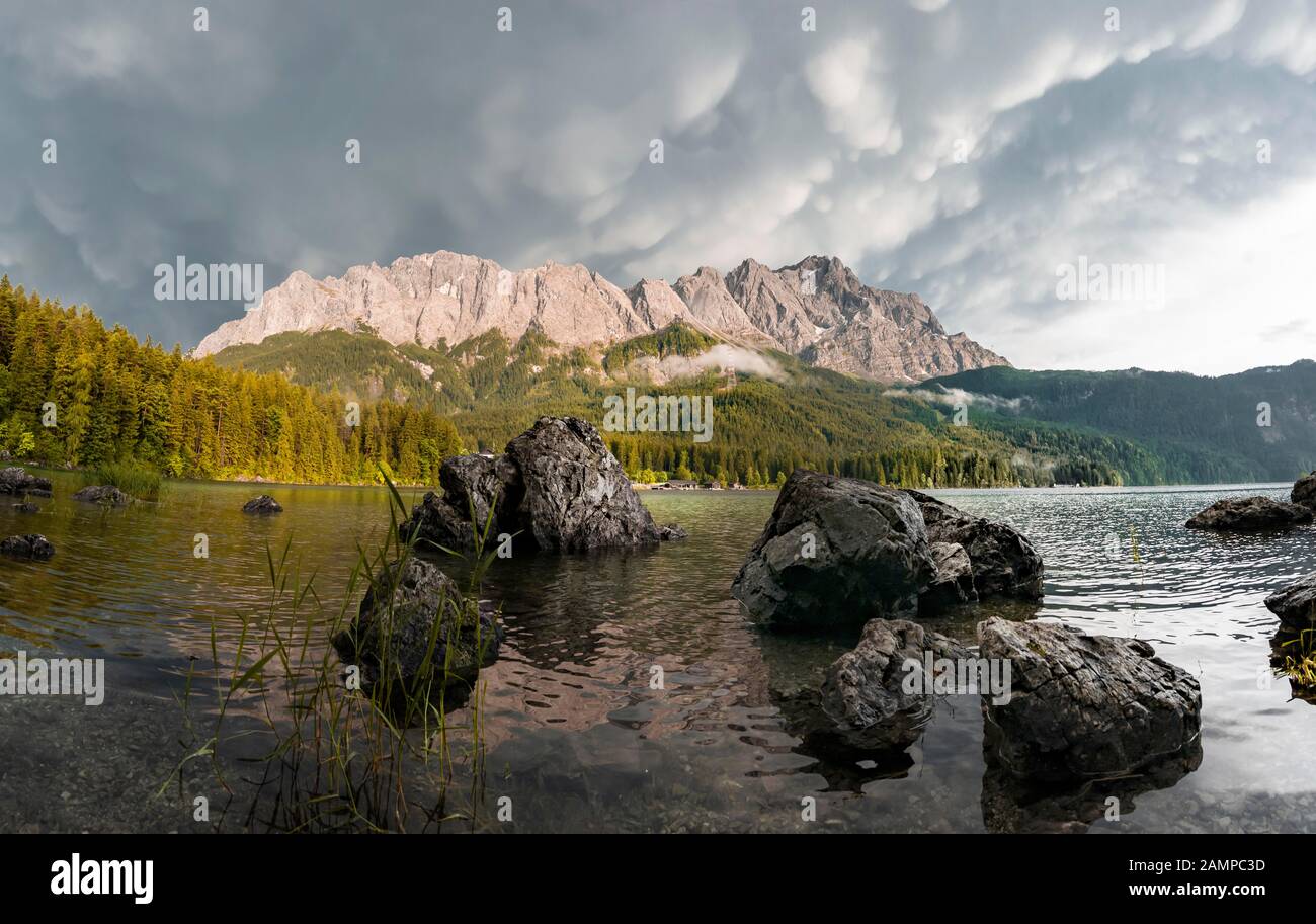 Rocks on the shore, Eibsee lake in front of Zugspitze massif with ...