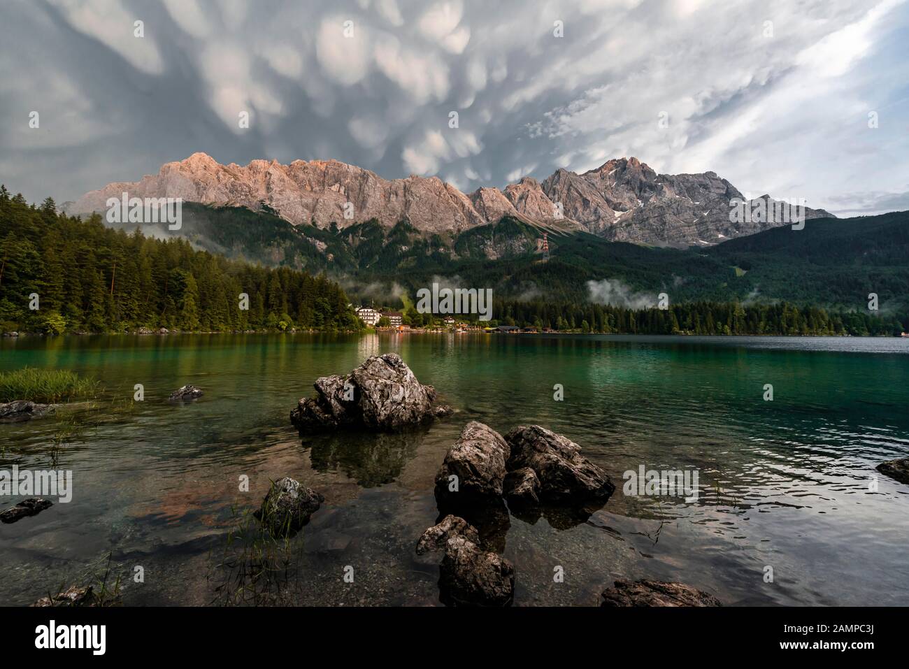 Rocks on the shore, Eibsee lake in front of Zugspitze massif with ...