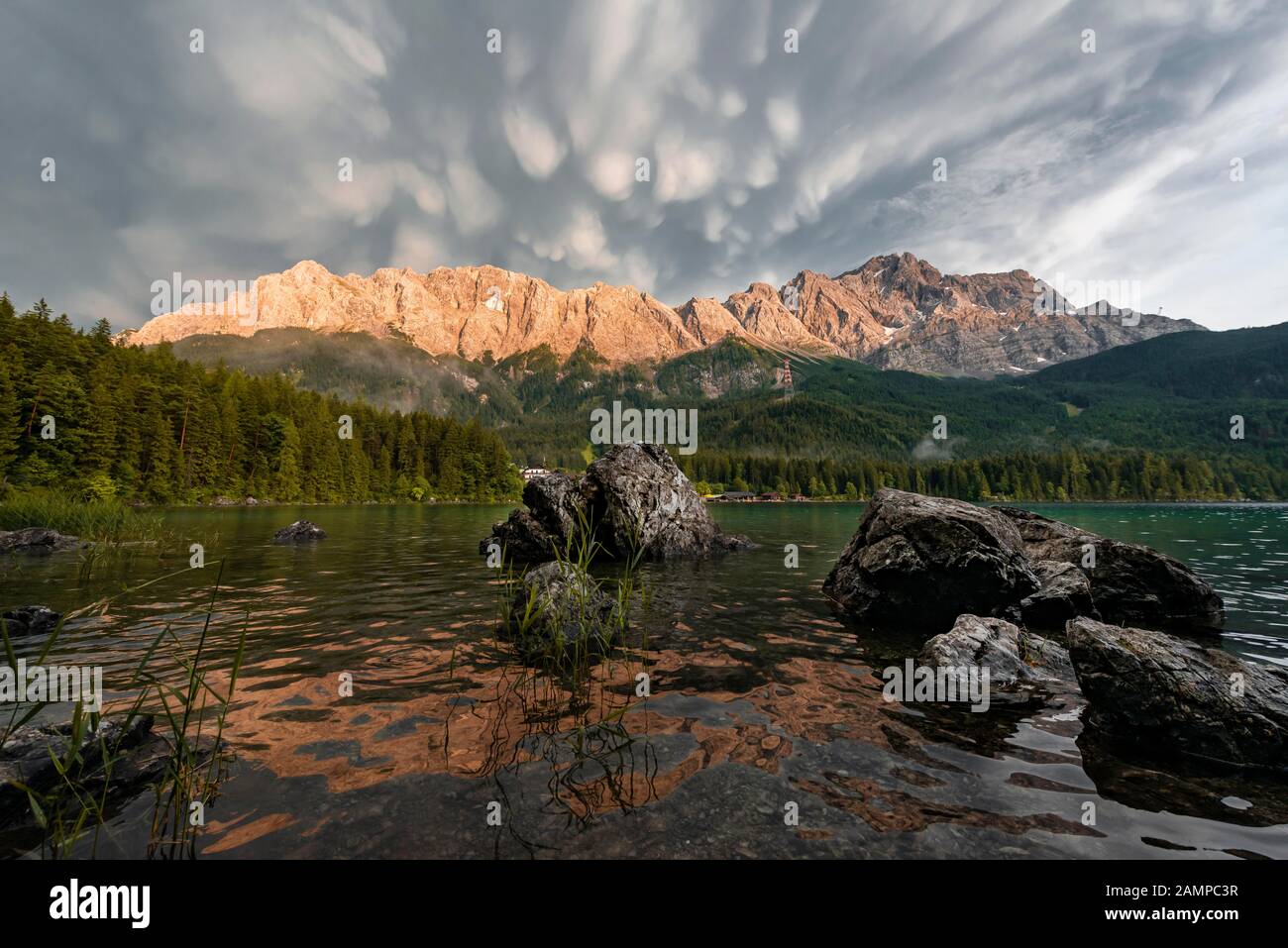 Rocks on the shore, Eibsee lake in front of Zugspitze massif with ...