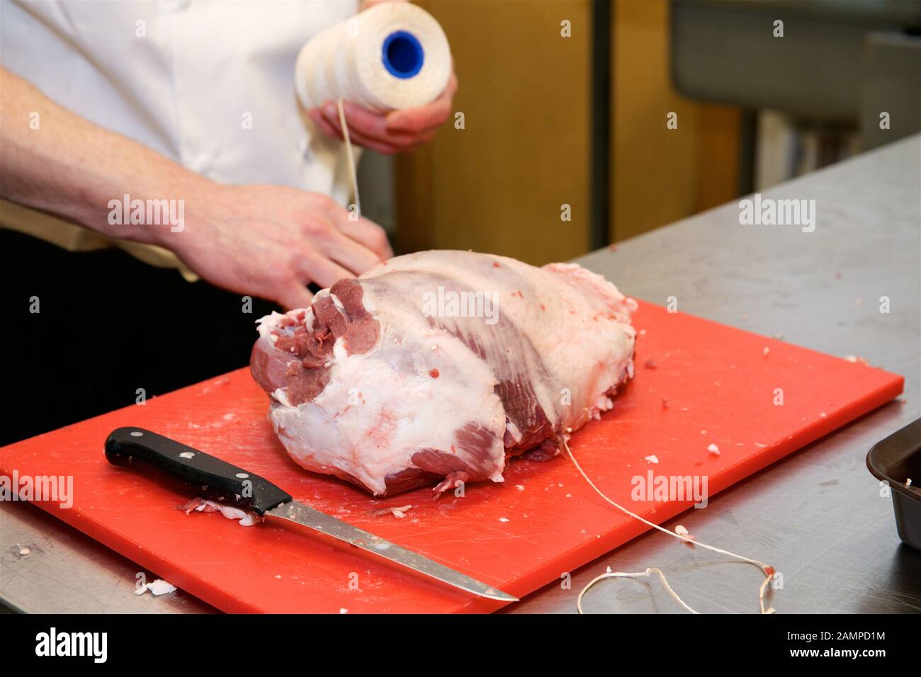 Restaurant chef preparing a joint of beef. Stock Photo