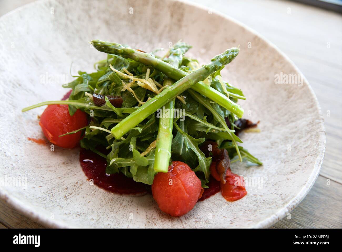 Beetroot and tomato salad with rocket and asparagus. Stock Photo