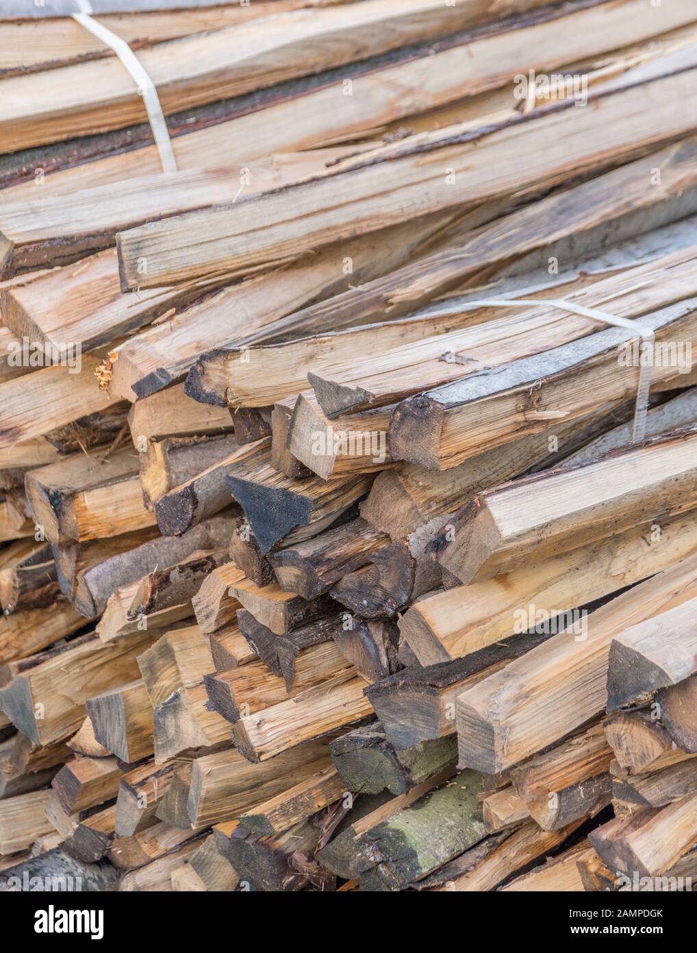 Pile of stacked wood fencing staves. Metaphor lumber industry, timber yard, fencing posts. Stock Photo