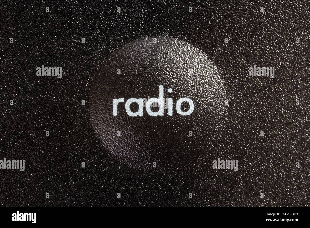 Macro close up photograph of radio selection button on remote controller. Stock Photo