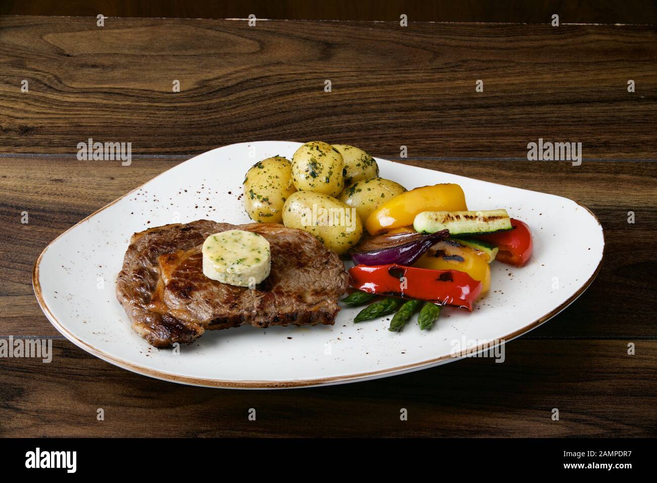 Irish sirloin steak served with baby new potatoes and roasted vegetables. Stock Photo