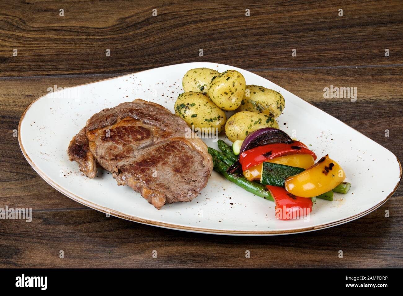 Irish sirloin steak served with baby new potatoes and roasted vegetables. Stock Photo