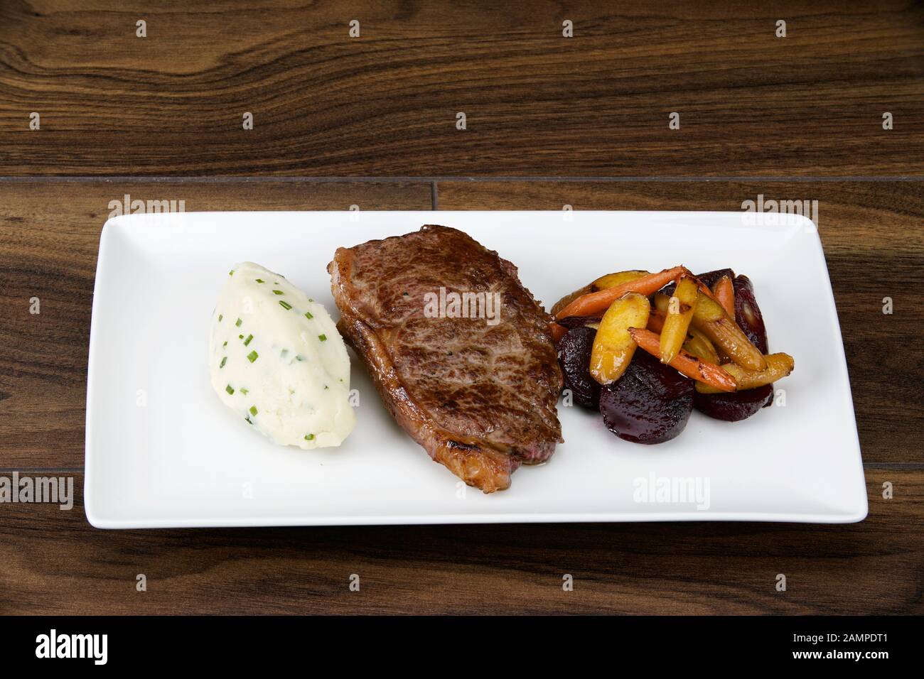 Irish sirloin beef steak served with creamy mashed potatoes and roasted vegetables. Stock Photo