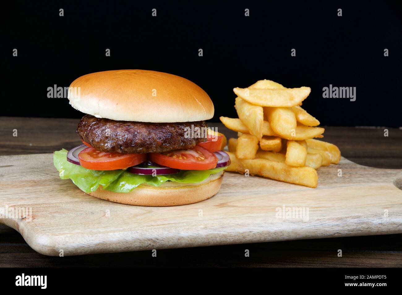 Close-up shot of a delicious hamburger served with crispy french fries. Stock Photo