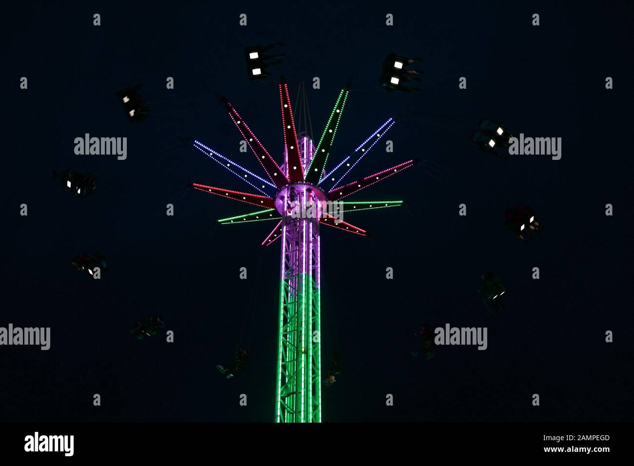 Amusement park high swing ride at night. Stock Photo