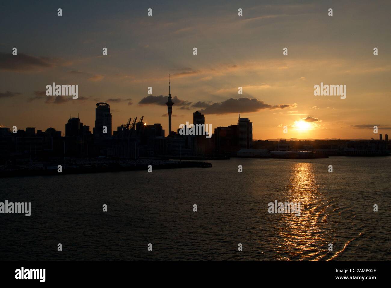 Silhouette of the Auckland, New Zealand skyline at sunset. Stock Photo
