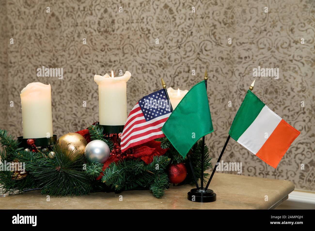 Irish American Christmas background: Miniature Irish and American flags with Christmas decorations and candles. Stock Photo