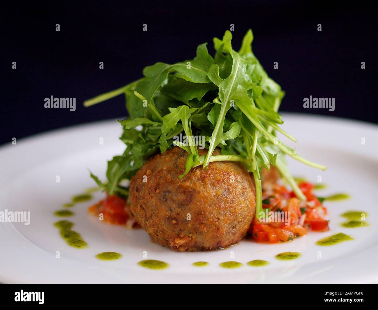 Deep fried goats cheese served with rocket leaves and tomato salsa