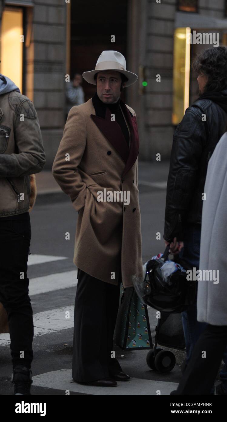 Milan, Alessandro Ristori in the center for the men's fashion week Alessandro Ristori, leader of 'Alessandro Ristori & Portofino, the musical group that rose to the forefront of the news for playing at the wedding of CHARLOTTE CASIRAGHI and DIMITRI RASSAM and known for years in the Principality of Monaco, he arrives in the center elegantly dressed and after shopping at 'Gucci' he stops to talk to a friend. After the greetings he and Francesca Morini take a long walk in the streets of the quadrilateral. Stock Photo