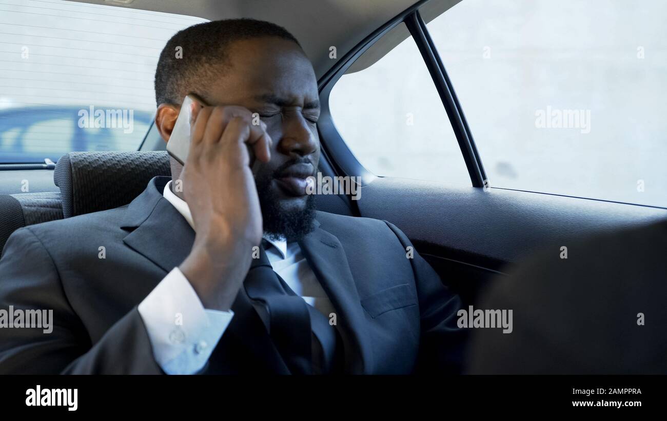 Stressed man having unpleasant phone conversation, marriage problems, bankrupt Stock Photo
