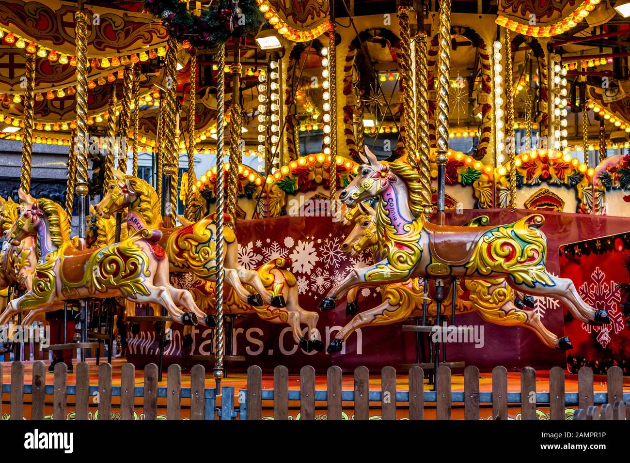 Yellow Vintage merry-go-round wooden horses in carusel Stock Photo