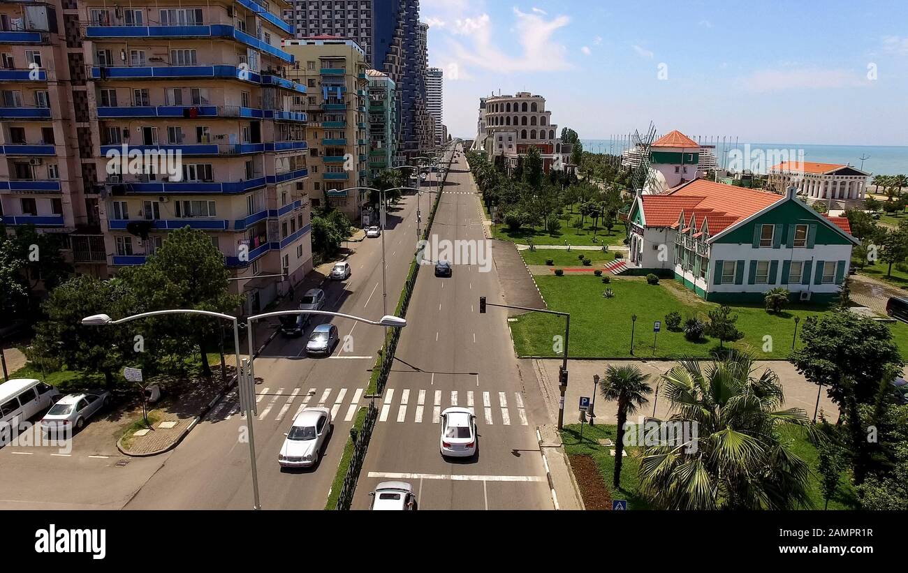 Boulevard with cars between apartment buildings and seafront in Batumi Georgia Stock Photo