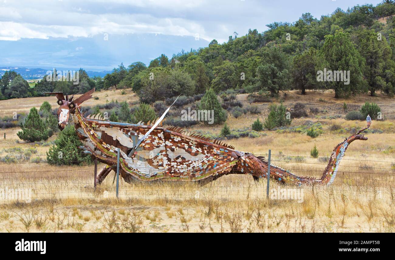 Replica of Fire Dragon, passing along valley, rolling hills. Stock Photo