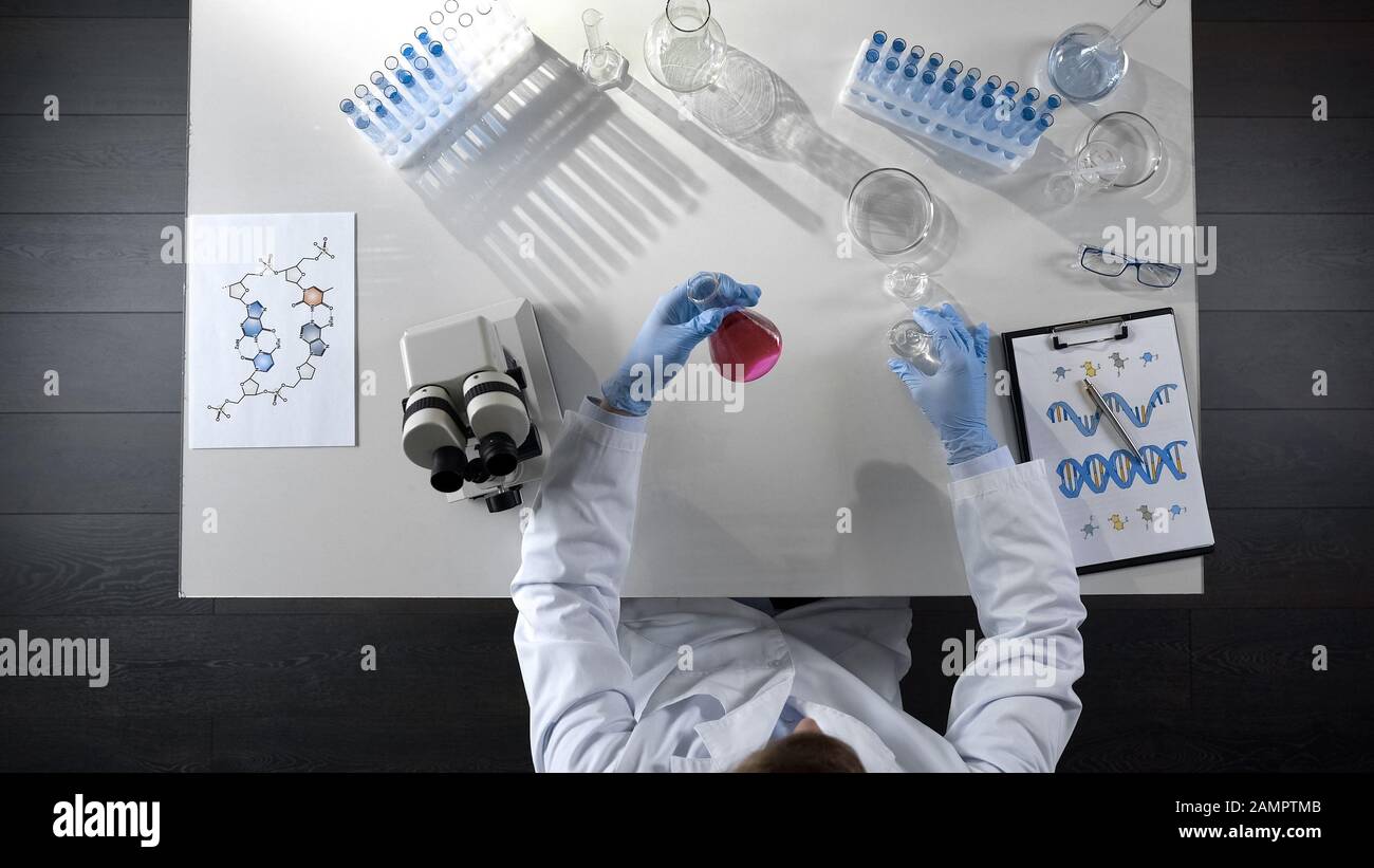 Lab worker adding liquid in hi-res stock photography and images - Alamy