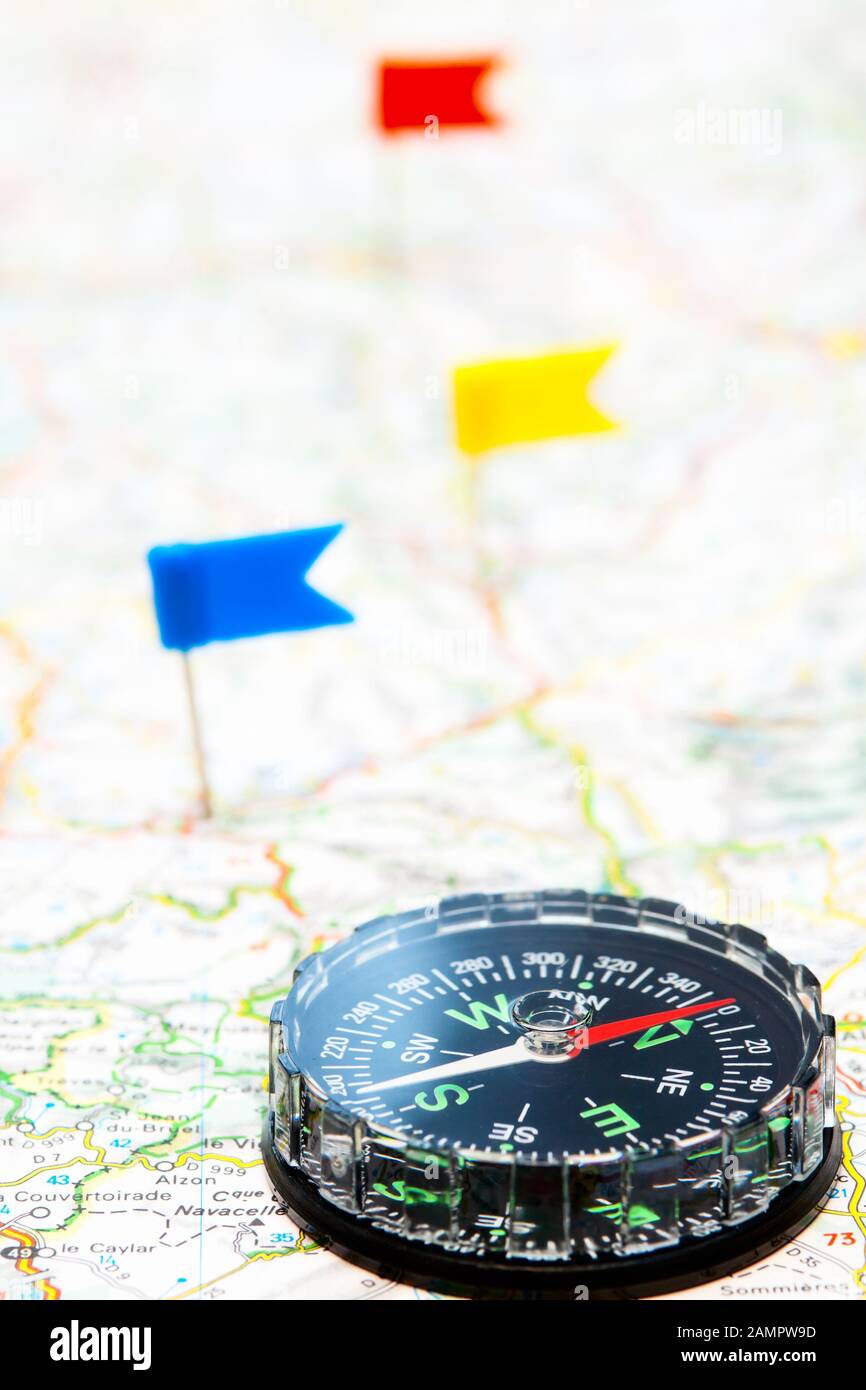 Compass Colours Map Compass on a map with color flag pins in background Stock Photo - Alamy