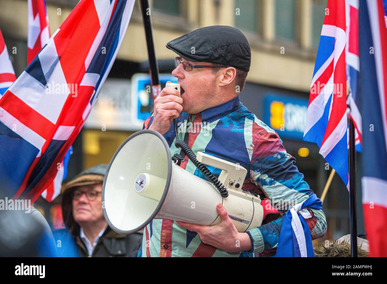 Glasgow, UK. 11th Jan, 2020. Pro-Unionist group leader Alistair McConnachie is seen shouting over his megaphone during the counter-protest.80,000 supporters came out in support of Scottish Independence following the UK General Election and the upcoming date of January 31st when the UK will leave the European Union, dragging Scotland out of it against its will, as a result the group All Under One Banner held an Emergency march through the center of Glasgow to protest against both London rule and Brexit. Credit: Stewart Kirby/SOPA Images/ZUMA Wire/Alamy Live News Stock Photo
