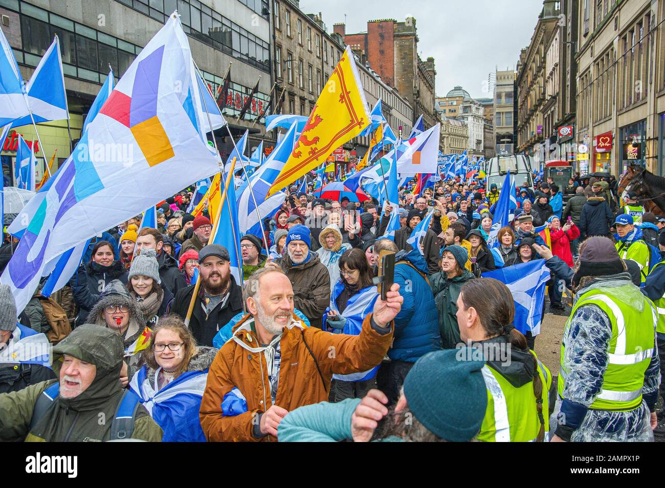 Glasgow, UK. 11th Jan, 2020. An overview of the pro-independence march as they pass the counter-protest lead by Alistair McConnachie.80,000 supporters came out in support of Scottish Independence following the UK General Election and the upcoming date of January 31st when the UK will leave the European Union, dragging Scotland out of it against its will, as a result the group All Under One Banner held an Emergency march through the center of Glasgow to protest against both London rule and Brexit. Credit: Stewart Kirby/SOPA Images/ZUMA Wire/Alamy Live News Stock Photo
