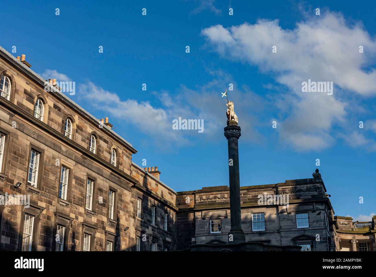 The Unicorn statue called Mercat Cross with golden light shining on it.  The Edinburgh City Chambers are in the background. Stock Photo