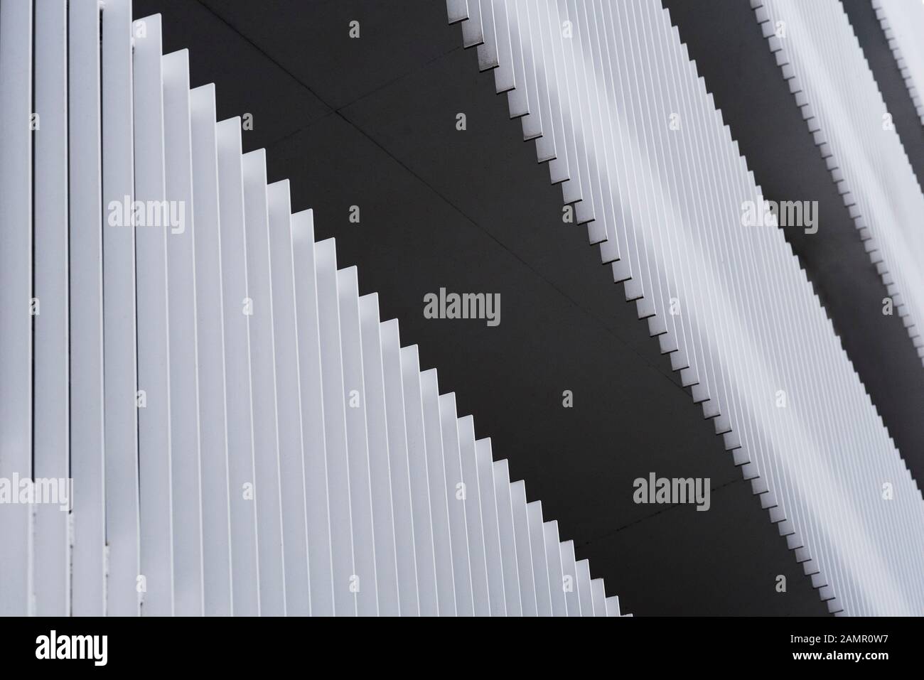Abstract pattern of metal slats forming privacy railings on modern apartment block walkways. Stock Photo