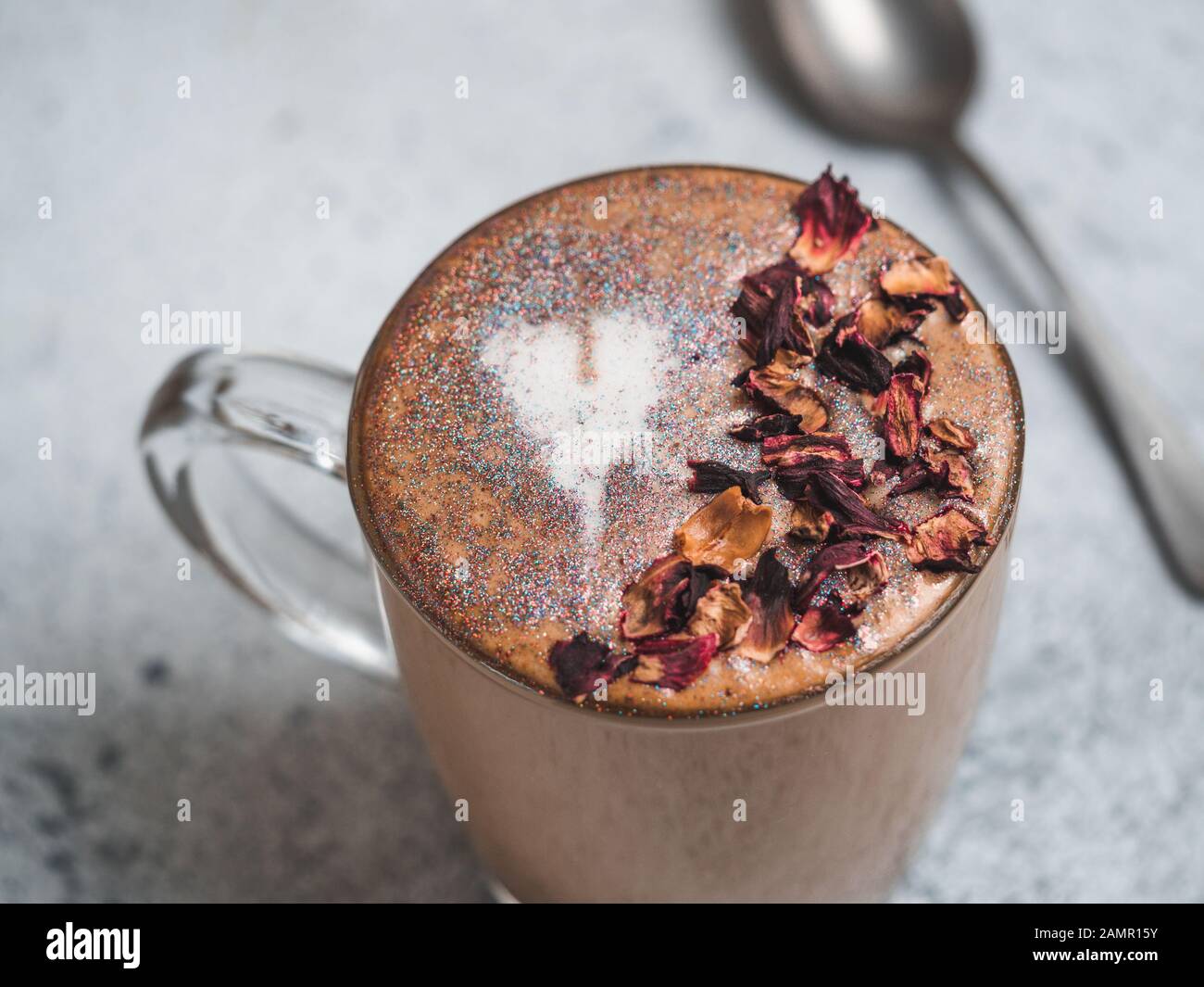 Trendy Coffee with edible glitter and dried rose petals. Cup of sparkly  coffee or diamond cappuccino on gray table. Copy space for text Stock Photo  - Alamy
