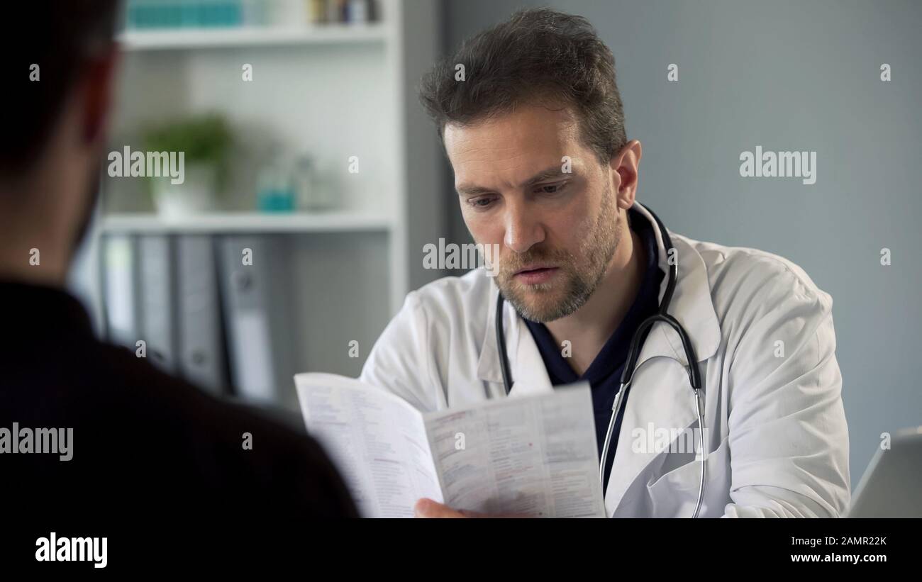 Therapist reading patients test results making diagnosis, healthcare