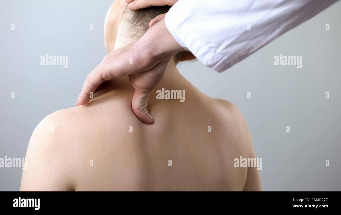 Neurologist examining female neck, examining head and shoulder, healthcare Stock Photo