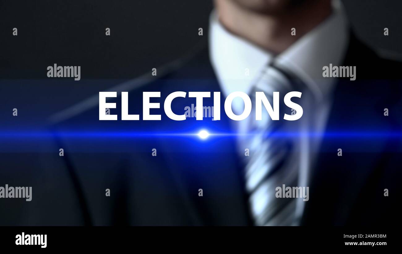 Elections, politician in suit standing in front of screen, political campaign Stock Photo