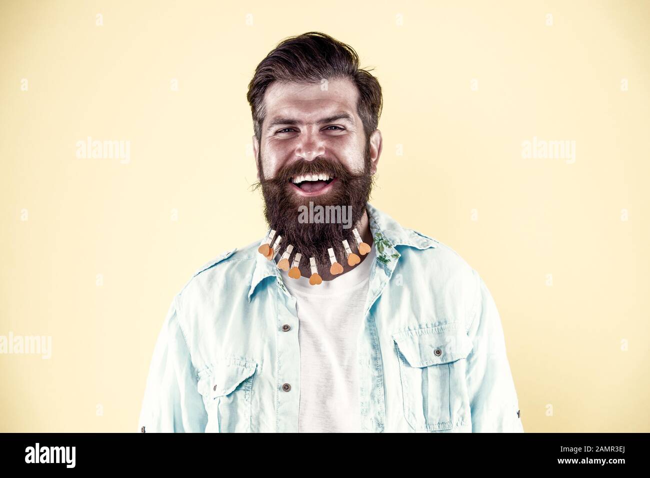 Perfect male. brutal male put clothespin with hearts on beard. bearded