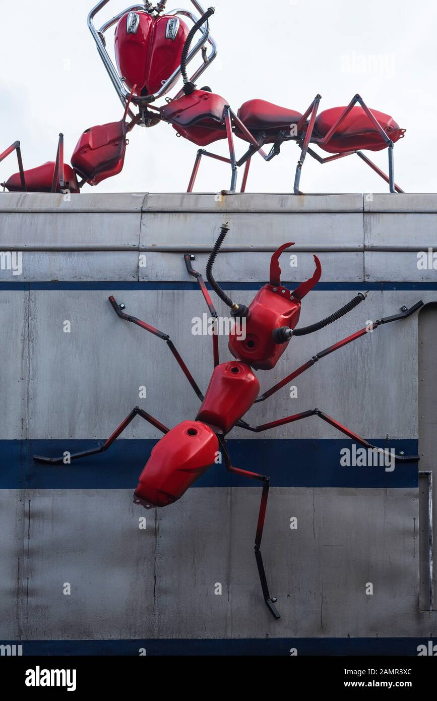 Red ant sculptures crawling over a train carriage at a restaurant in London Bridge, London,UK. Stock Photo