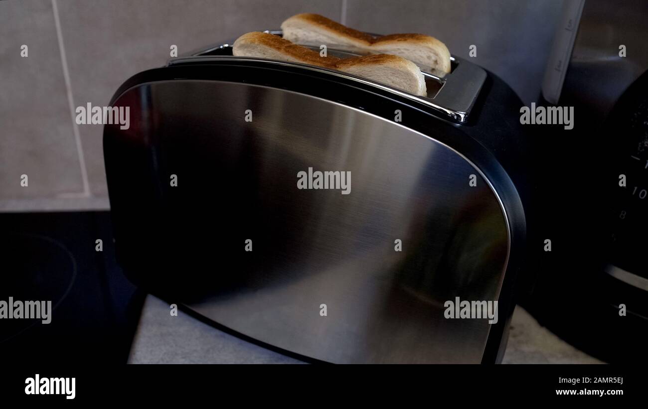 Toasts jumped out of toaster, fast breakfast with use of electrical