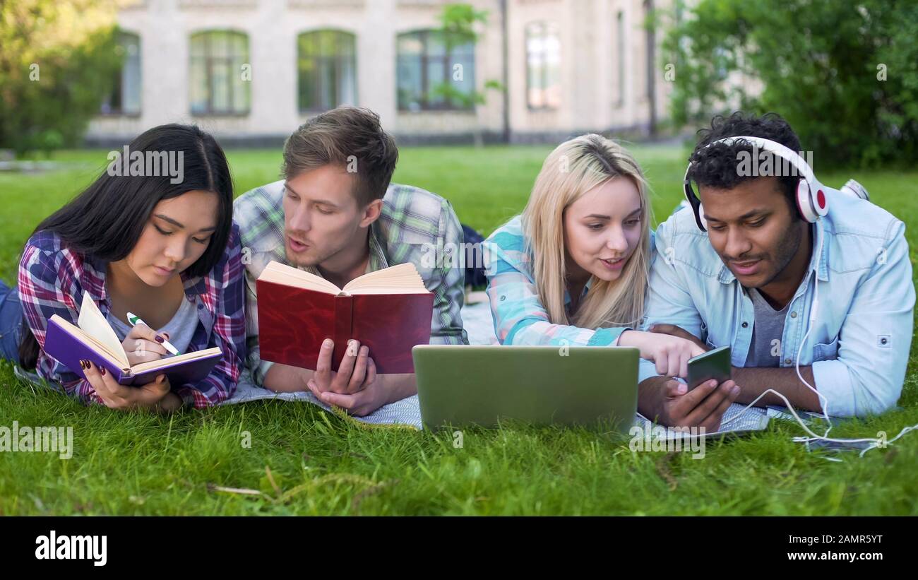 Multiracial students preparing for lessons, talking with each other, education Stock Photo