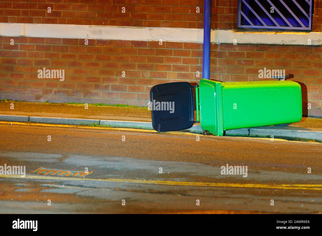 A wheelie bin blown over by wind Stock Photo Alamy