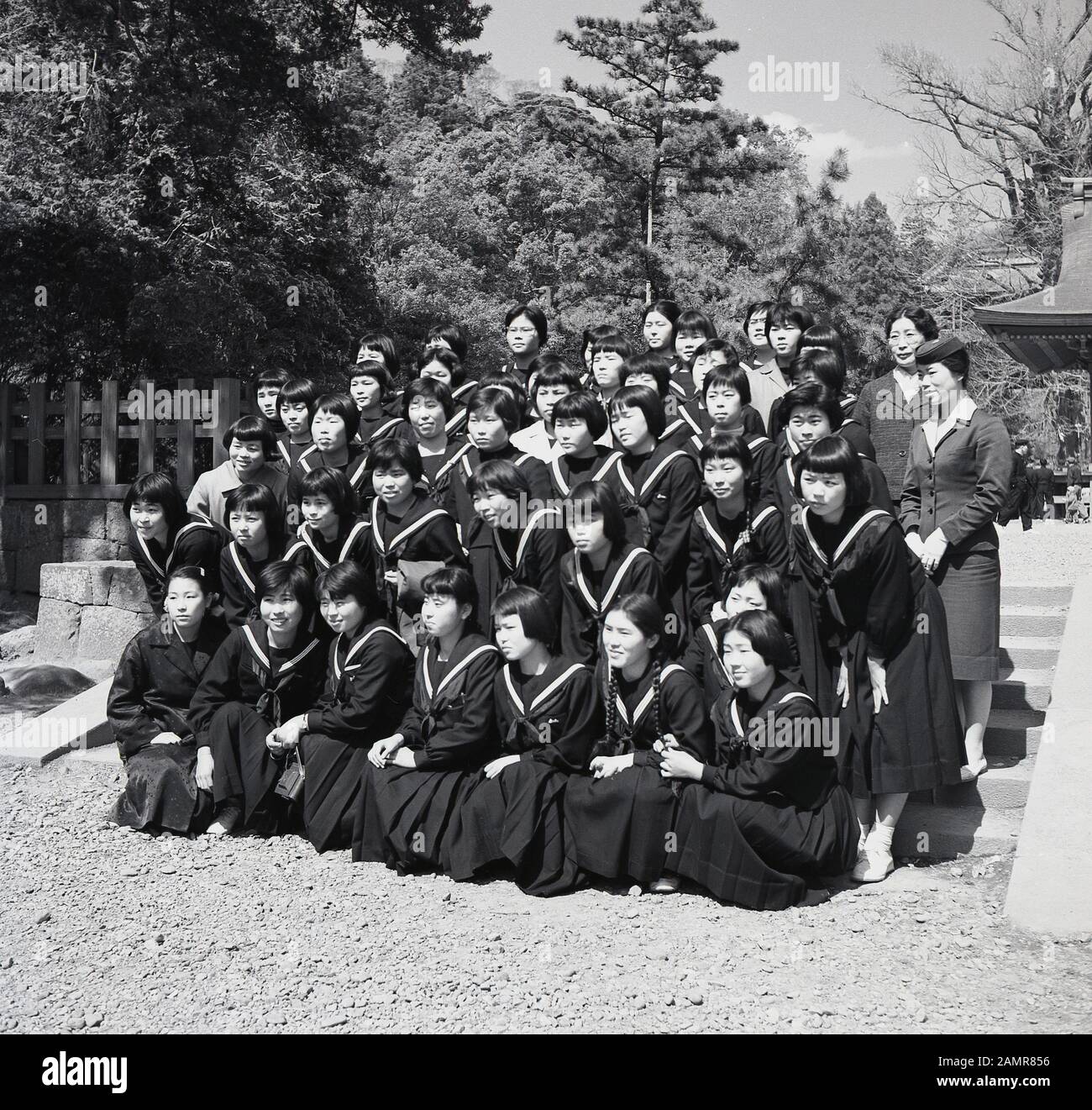 1960s, historical, group of uniformed Japanese school girls on a school outing posing together for a picture, Japan. Stock Photo