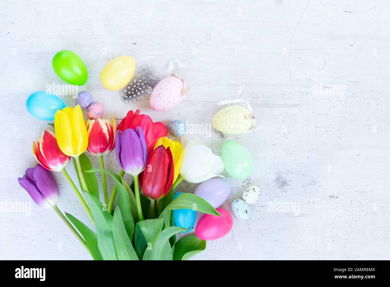 Easter colored eggs with tulips Stock Photo - Alamy
