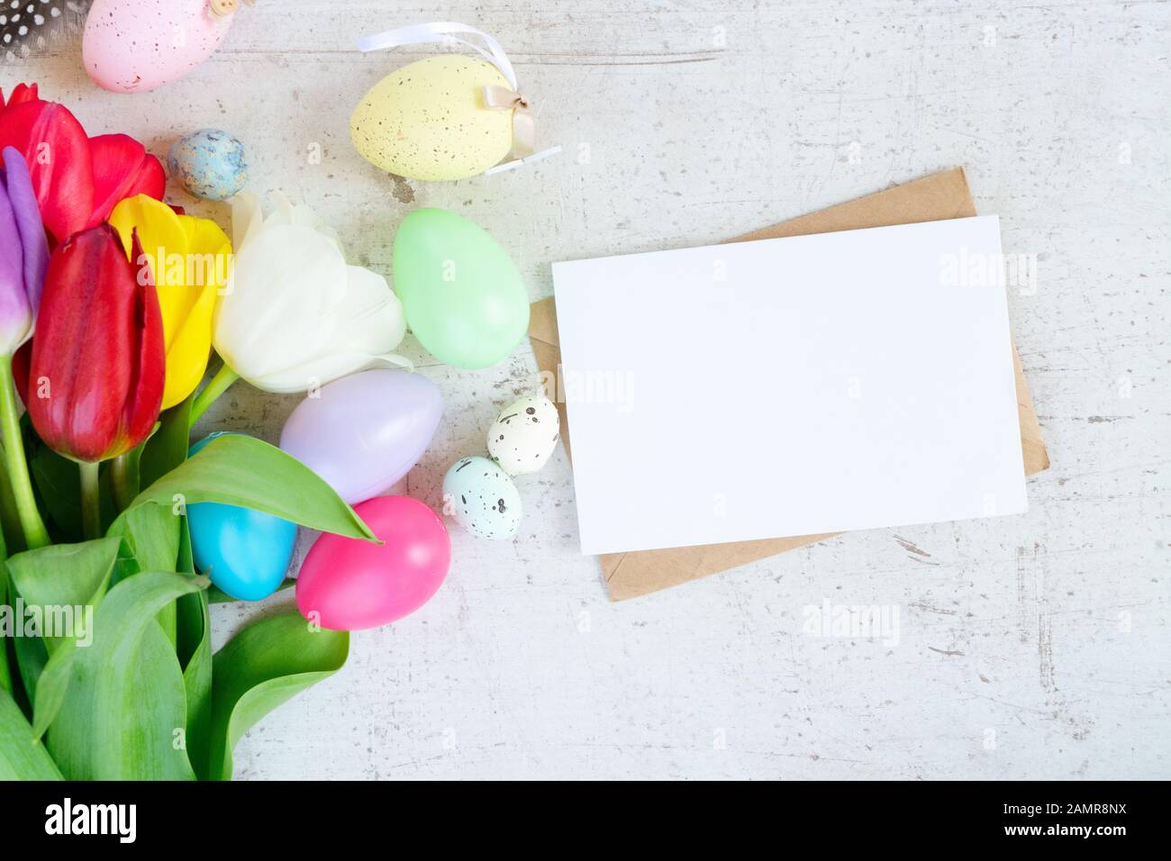 Easter colored eggs with tulips Stock Photo - Alamy