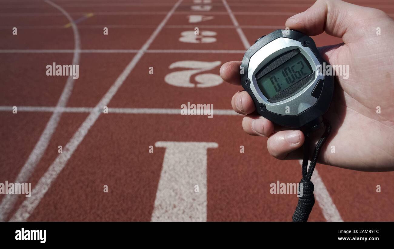 Man holds stopwatch with time ten seconds, world record, victory in competition Stock Photo
