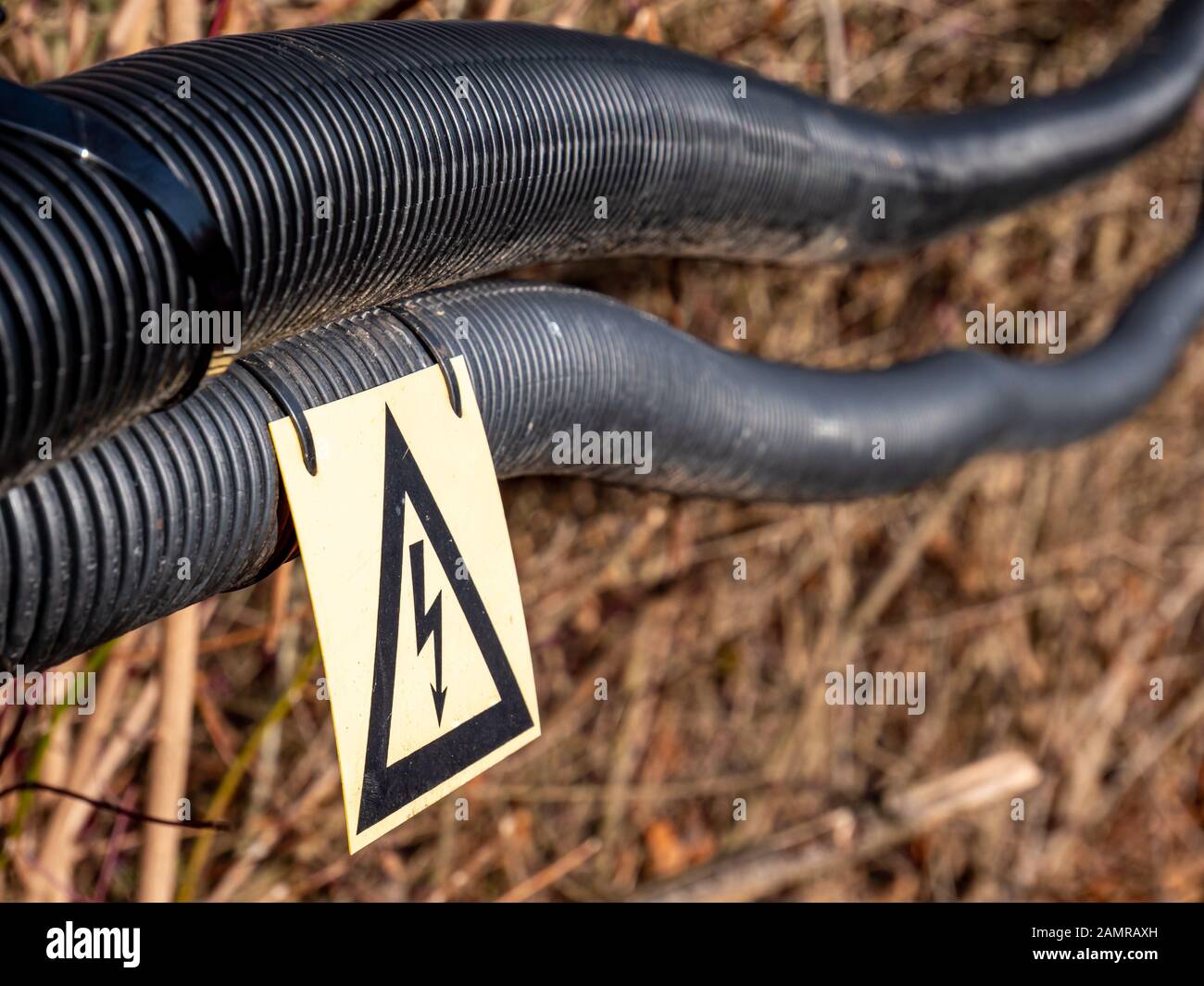 Attention power line with sign Stock Photo