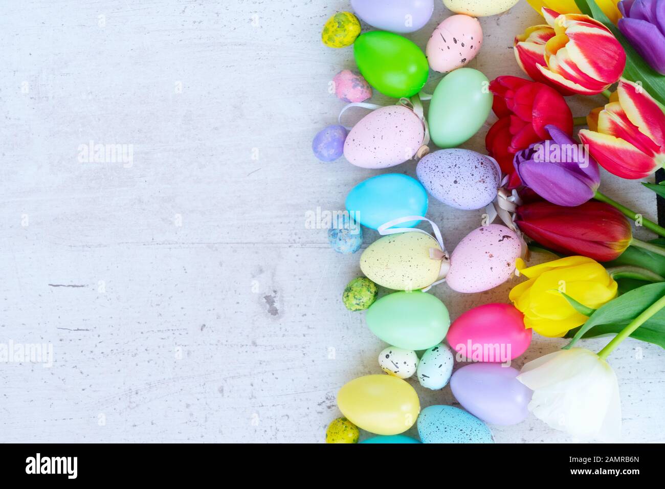 Easter colored eggs with tulips Stock Photo - Alamy