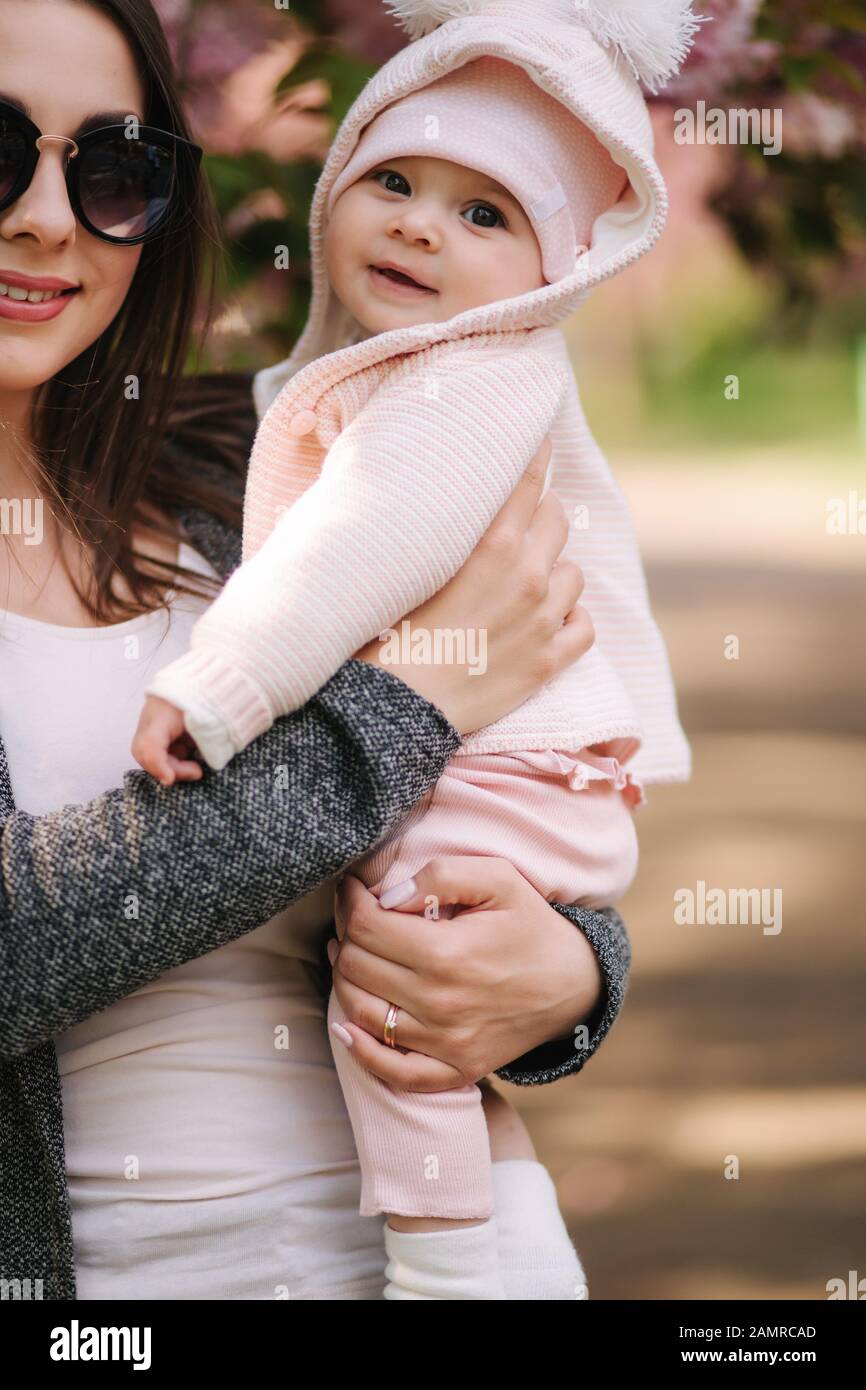 Portrait of cute little baby girl outside with mom. Beautiful girl ...