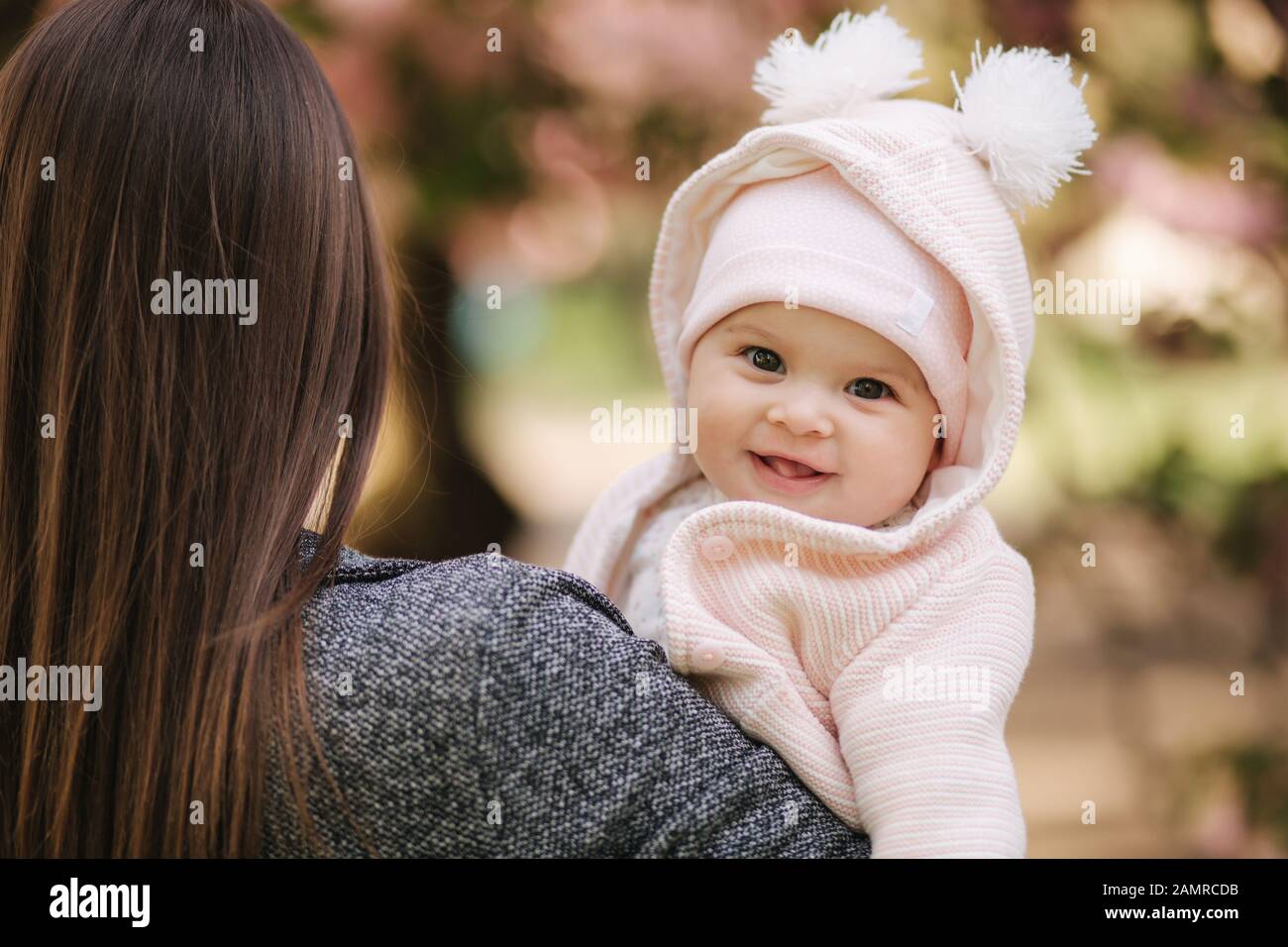 Portrait of cute little baby girl outside with mom. Beautiful girl ...