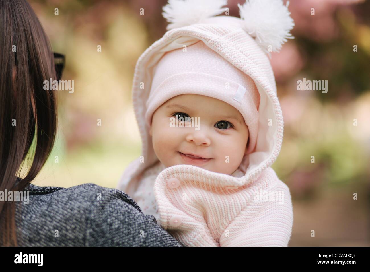 Portrait of cute little baby girl outside with mom. Beautiful girl ...