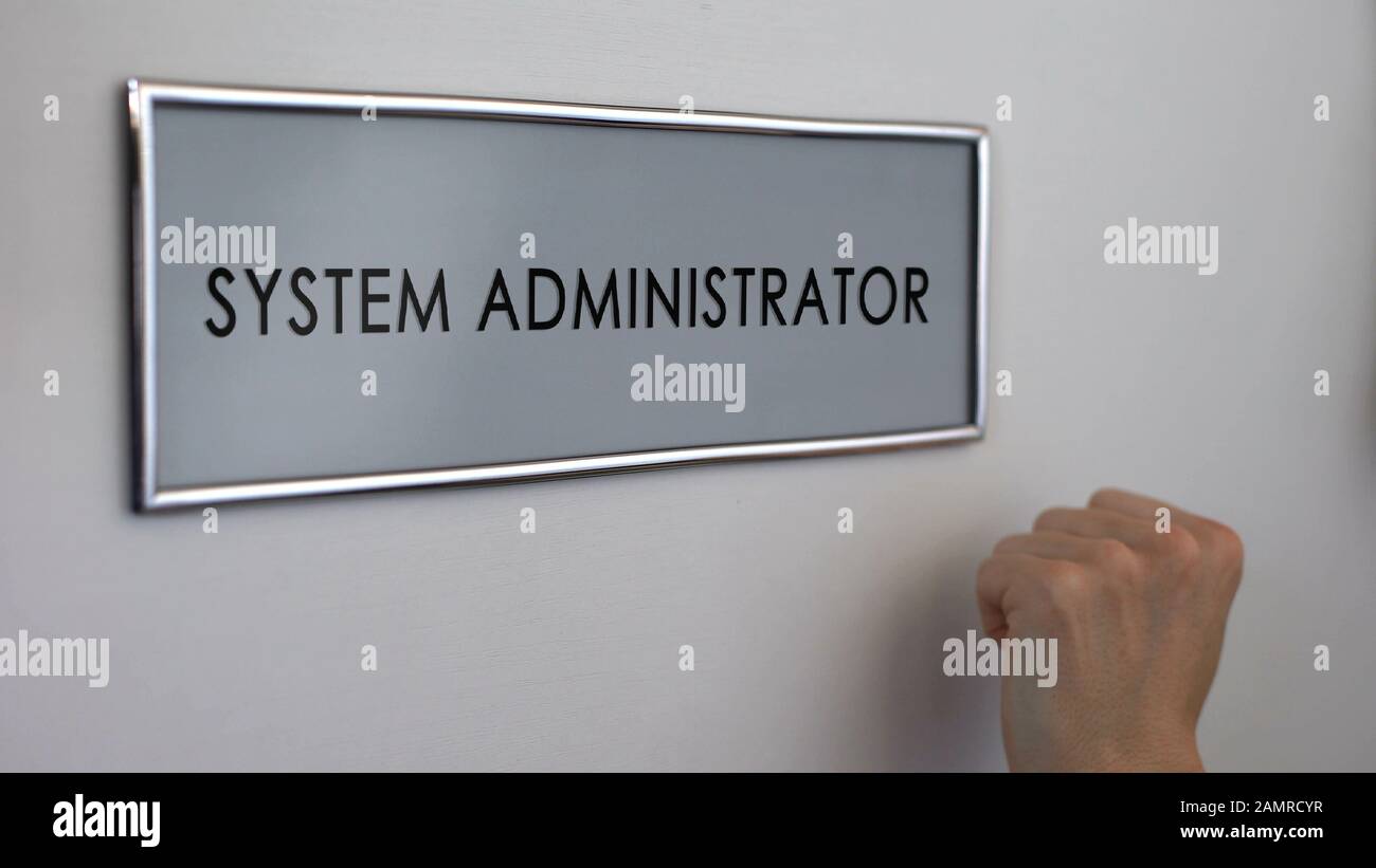System administrator office door, hand knocking closeup, computer specialist Stock Photo