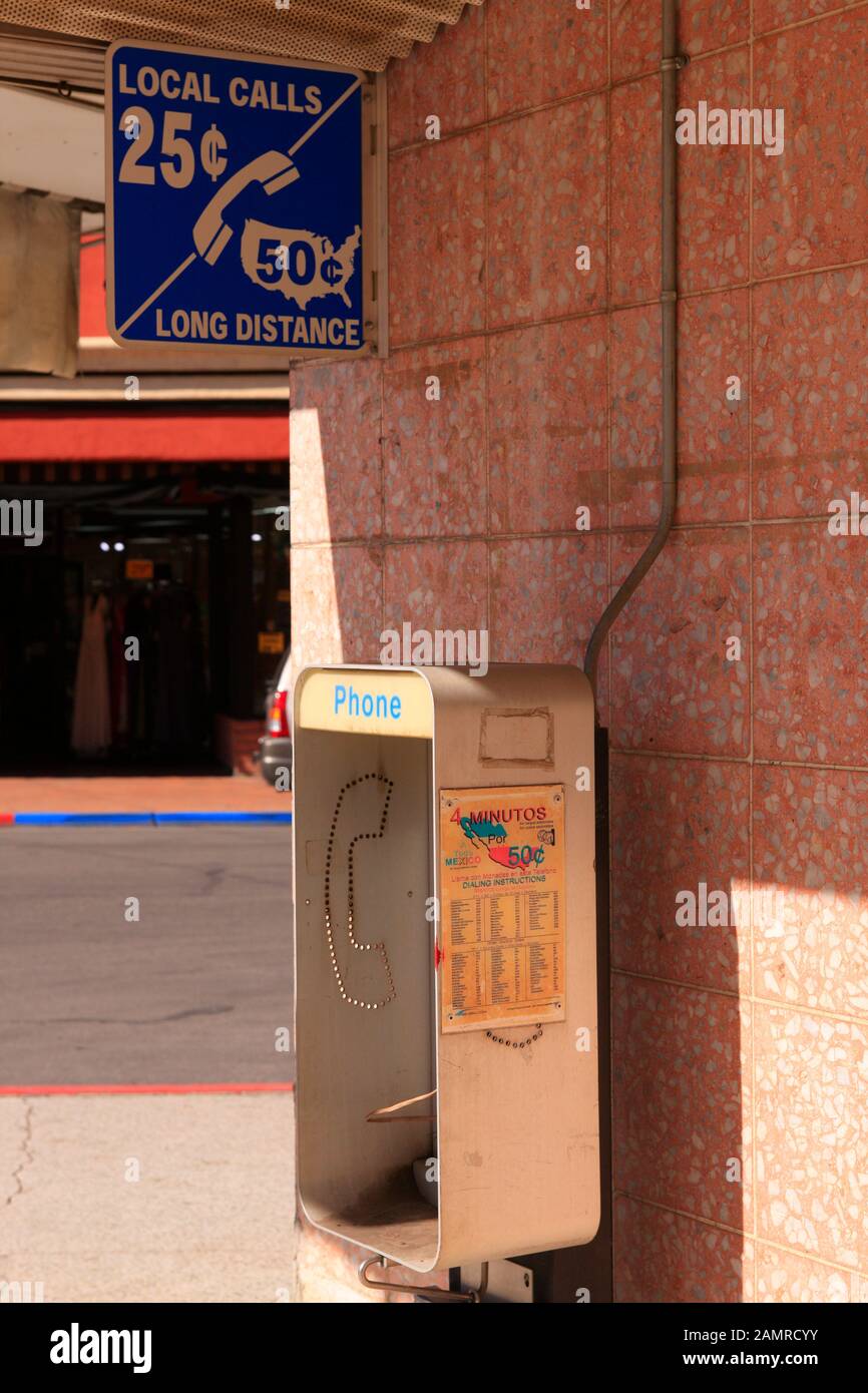 Local and Long distance payphone across the street from the US-Mexico border crossing gate in Nogales, AZ Stock Photo