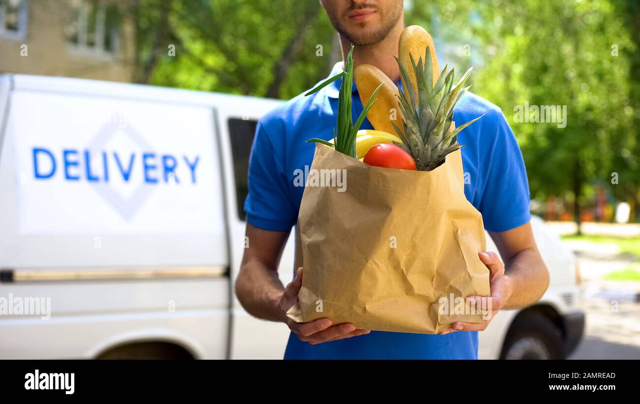 Food delivery service, male worker holding grocery bag, express food ...